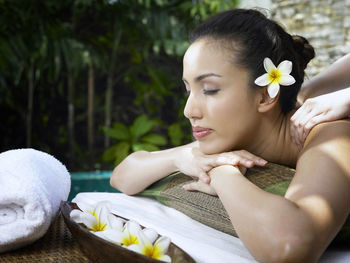 Cropped hands of woman massaging customer at poolside