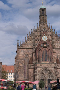 Exterior of historic church against cloudy sky