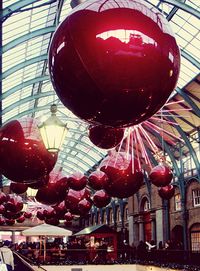 Low angle view of illuminated lanterns hanging from ceiling