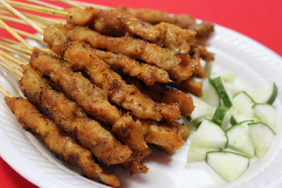 Close-up of meat skewers on plate