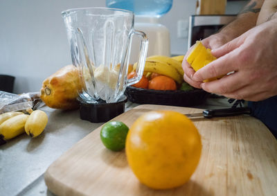 Cropped image of person preparing food on table at home