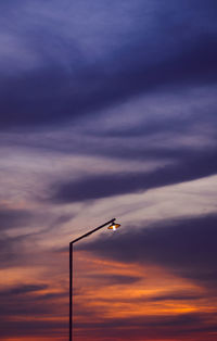 Low angle view of silhouette street light against sky during sunset