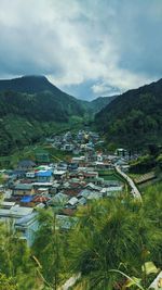 High angle view of buildings and mountains against sky