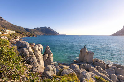 Panoramic view of sea against clear blue sky