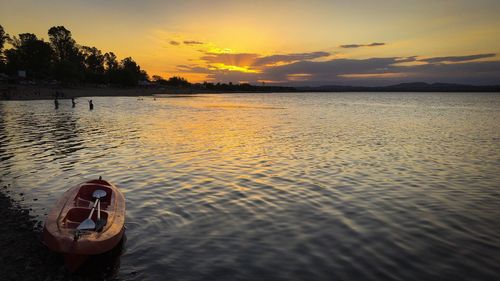 Scenic view of lake against sky during sunset