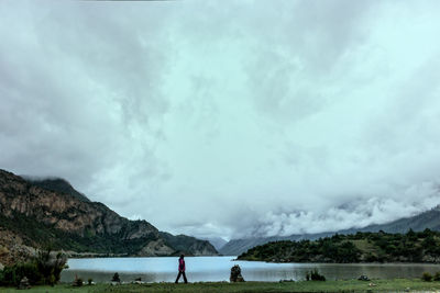 Scenic view of sea and mountains against sky