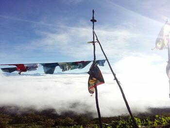 Low angle view of fortune flag hanging against sky, cloud ocean, nature, early morning, prayer flags