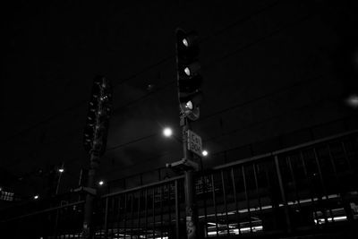 Low angle view of illuminated street light at night