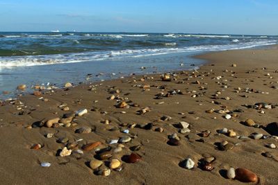 Pebbles on beach against sky