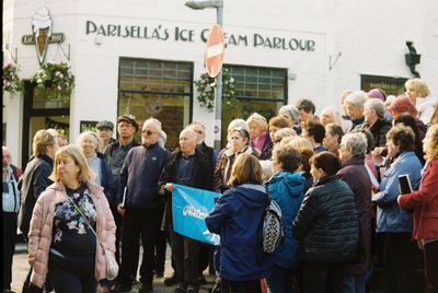 Group of people standing on street in city