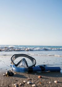Rear view of woman swimming in sea against clear sky