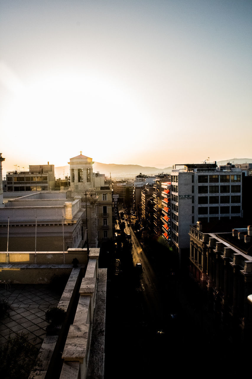 HIGH ANGLE VIEW OF BUILDINGS AGAINST SKY DURING SUNSET