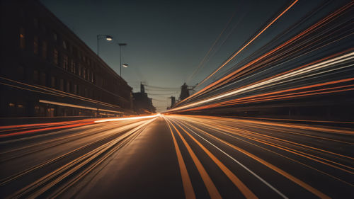 Low angle view of light trails on road at night