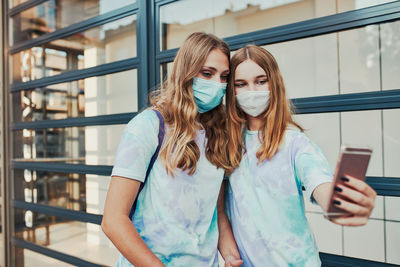 Portrait of young woman using smart phone