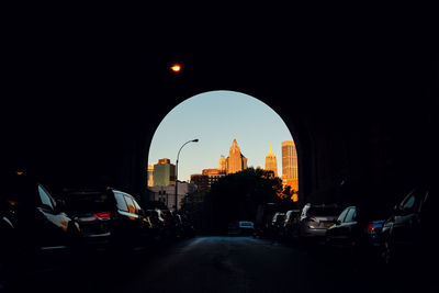 Traffic on road in city against sky