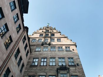 Low angle view of buildings against clear blue sky