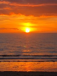 Scenic view of sea against romantic sky at sunset