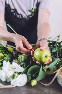 Midsection of person preparing fruits