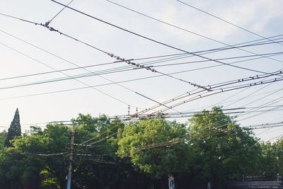 Low angle view of electricity pylon against sky