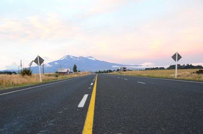 Empty road along countryside landscape