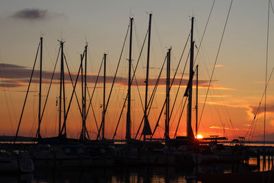 Sailboats in marina at sunset