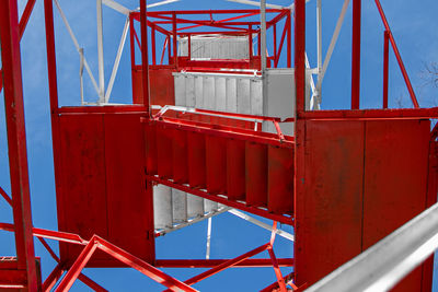 Low angle view of red and white stairs against sky