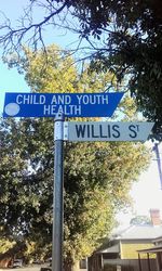 Low angle view of road sign against sky