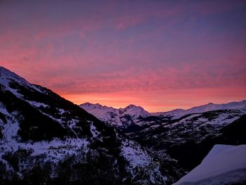 Scenic view of snowcapped mountains against sky during sunset