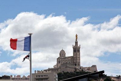 Low angle view of building against cloudy sky