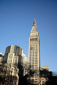 Low angle view of buildings against clear blue sky