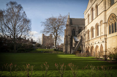 Buildings against sky with lawn in foreground