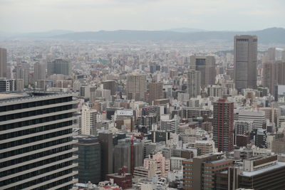 High angle view of modern buildings in city against sky