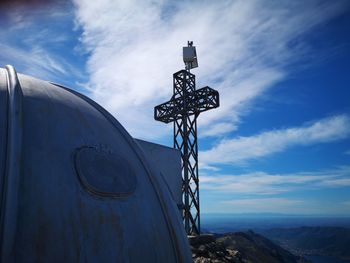 Low angle view of cross against blue sky