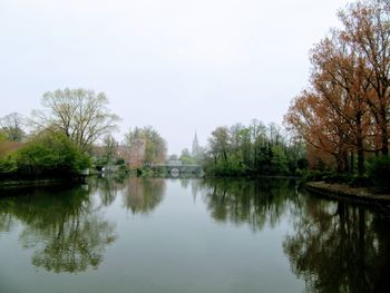 Scenic view of lake by trees against clear sky