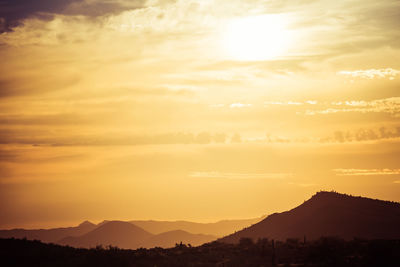 Scenic view of silhouette mountains against sky during sunset