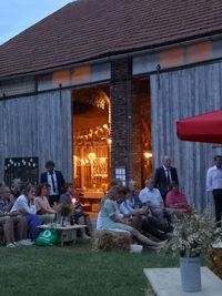 Group of people in restaurant against building