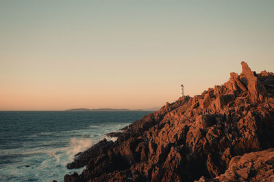 Scenic view of sea against clear sky during sunset