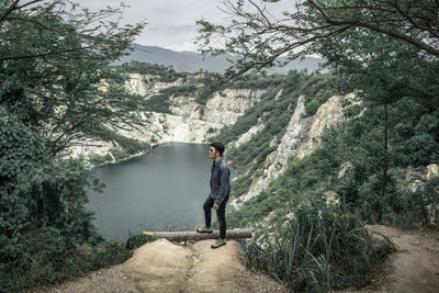 Man standing on mountain against trees