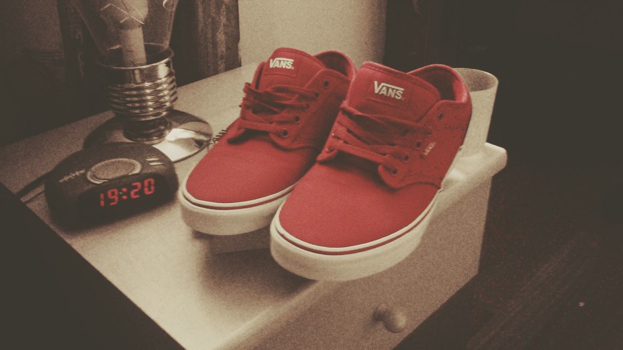 indoors, still life, table, high angle view, red, text, close-up, communication, no people, wood - material, shoe, absence, western script, flooring, book, single object, pair, empty, home interior, day