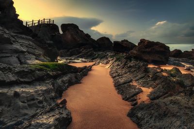 Scenic view of beach against sky during sunset