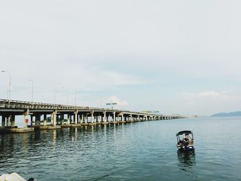 Bridge over sea against sky