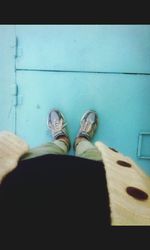 Low section of woman standing on tiled floor