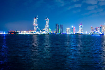 Boats in sea against sky at night