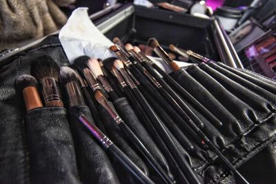 High angle view of makeup artist paintbrushes on table. 