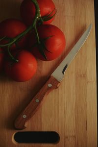 Directly above shot of tomatoes and knife on cutting board