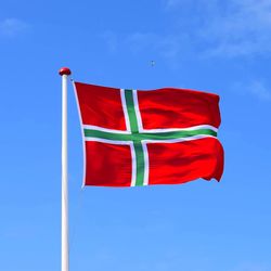 Low angle view of flag against blue sky