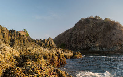 Scenic view of sea and mountains against sky