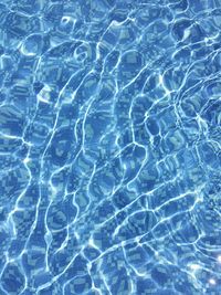 Full frame shot of rippled water in swimming pool on sunny day