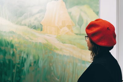 Young woman looking at painting