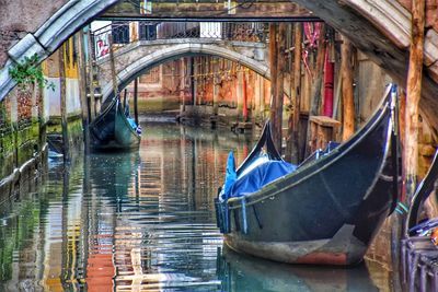 View of boats moored in canal venice italy